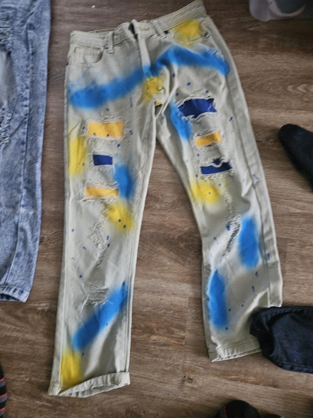 Men's Distressed Beige Jeans with Blue & Yellow Paint Accents